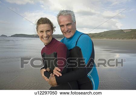 Couple embracing on a beach View Large Photo Image Stock Image - Couple embracing on a beach. Fotosearch