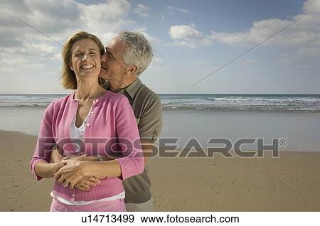 Stock Photo - Couple embracing on a beach. Fotosearch