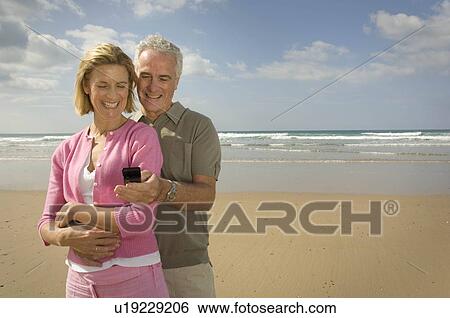 Stock Photograph - Couple embracing on a beach. Fotosearch