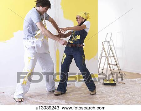 Stock Image - Couple messing around with paint.. Fotosearch