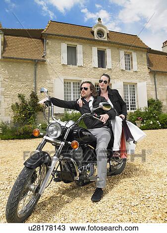 Stock Image - Couple on motorbike. Fotosearch