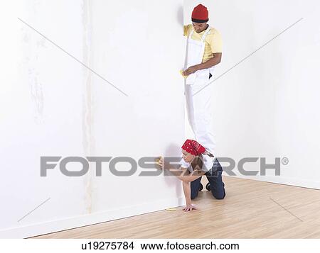 Picture - Couple painting wall.. Fotosearch