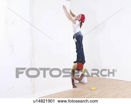 Couple painting wall. View Large Photo Image Stock Image - Couple painting wall.. Fotosearch