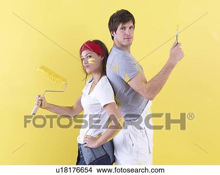 Couple posing in front of wall. View Large Photo Image Picture - Couple posing in front of wall.. Fotosearch