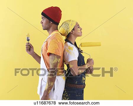 Couple posing in front of wall. View Large Photo Image Stock Photo - Couple posing in front of wall.. Fotosearch