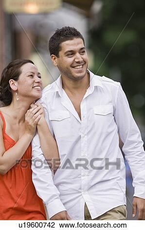 Stock Image - Couple walking down street. Fotosearch