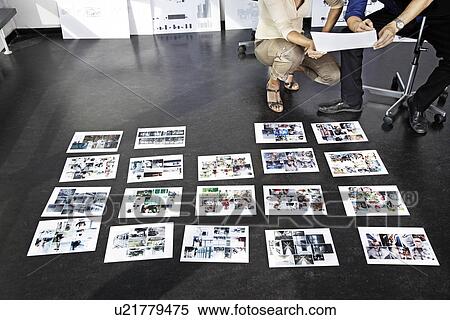Stock Photography - Coworkers concentrating on pictures. Fotosearch