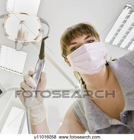 Stock Photo - Dental assistant with dental tools. Fotosearch