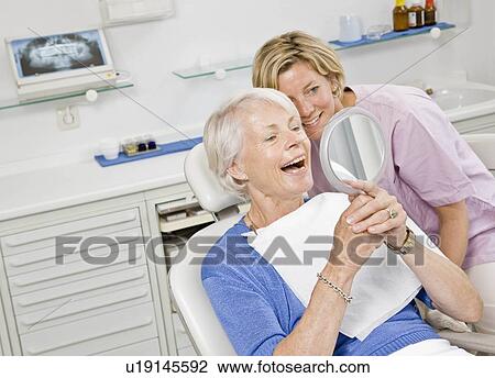 Dental assistant working on patient View Large Photo Image Stock Image - Dental assistant working on patient. Fotosearch