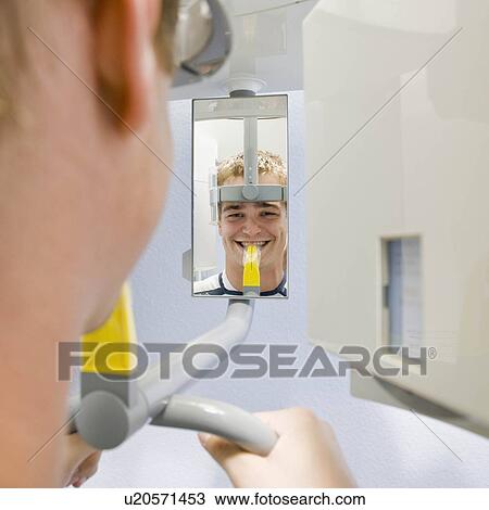 Stock Image - Dental patient having x-ray taken. Fotosearch