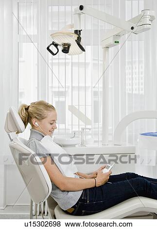 Dental patient listening to mp3 player View Large Photo Image Stock Photo - Dental patient listening to mp3 player. Fotosearch