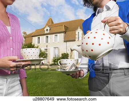 Drinking tea in front of country home View Large Photo Image Stock Photo - Drinking tea in front of country home. Fotosearch