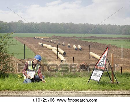 Stock Photograph - Ecologist Next To Motorway. Fotosearch
