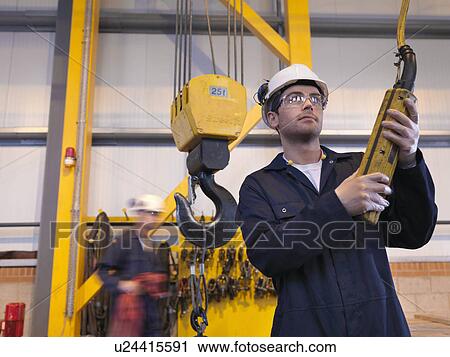 Stock Image - Engineer Controlling Crane. Fotosearch