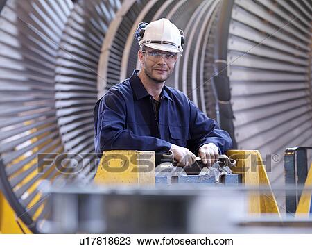 Stock Image - Engineer In Front Of Turbine. Fotosearch