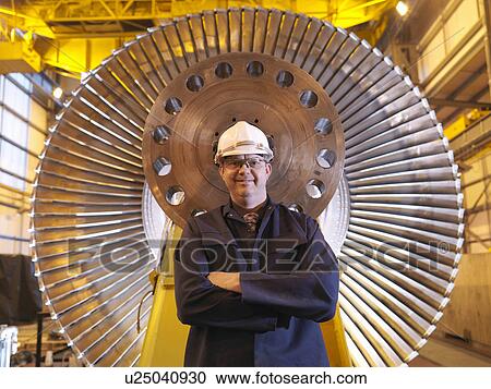 Stock Image - Engineer In Front Of Turbine. Fotosearch