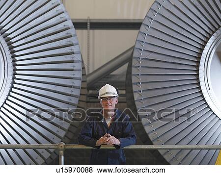 Engineer In Front Of Turbines View Large Photo Image Stock Photo - Engineer In Front Of Turbines. Fotosearch