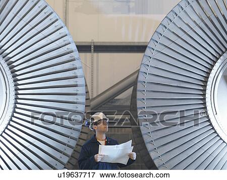 Engineer In Front Of Turbines View Large Photo Image Stock Photo - Engineer In Front Of Turbines. Fotosearch