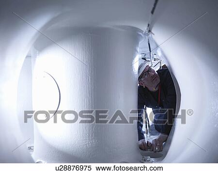 Stock Photography - Engineer In Wind Turbine. Fotosearch