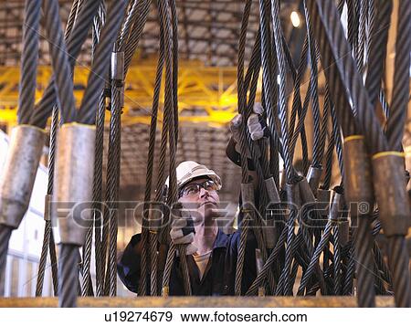 Stock Photo - Engineer Inspecting Cables. Fotosearch