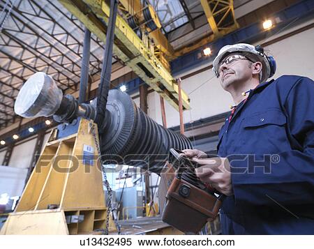 Engineer With Turbine And Crane View Large Photo Image Stock Photography - Engineer With Turbine And Crane. Fotosearch