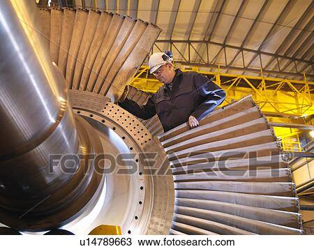 Stock Image - Engineer Working On Turbine. Fotosearch