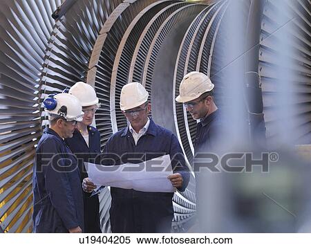 Stock Photography - Engineers In Front Of Turbine. Fotosearch
