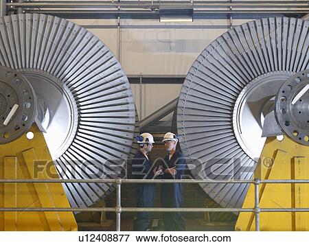 Stock Photo - Engineers In Front Of Turbines. Fotosearch