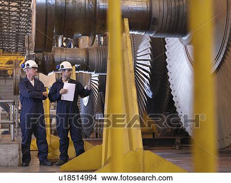 Picture - Engineers Next To Turbines. Fotosearch