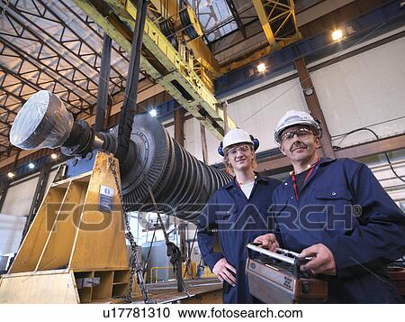 Stock Image - Engineers With Turbine And Crane. Fotosearch
