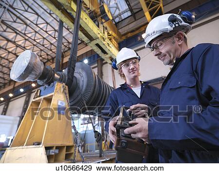 Engineers With Turbine And Crane View Large Photo Image Stock Photo - Engineers With Turbine And Crane. Fotosearch