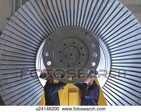 Stock Image - Engineers Working On Turbine. Fotosearch
