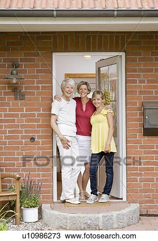 Stock Image - Family at the door way of a house. Fotosearch