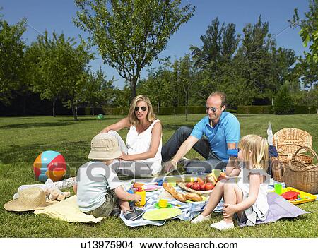 Family having a picnic in the garden View Large Photo Image Picture - Family having a picnic in the garden. Fotosearch