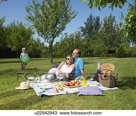Family having a picnic in the garden View Large Photo Image Stock Image - Family having a picnic in the garden. Fotosearch