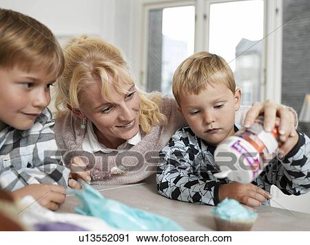 Family making Cupcakes View Large Photo Image Stock Image - Family making Cupcakes. Fotosearch