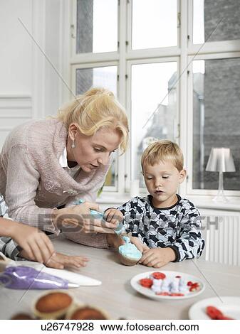 Stock Photo - Family making Cupcakes. Fotosearch