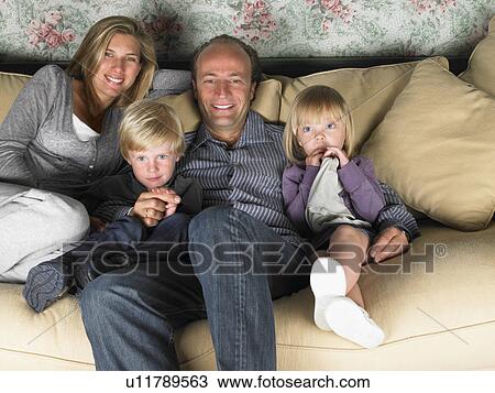 Stock Image - Family watching television. Fotosearch