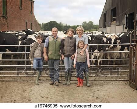 Stock Photography - Farmer And Family With Cows. Fotosearch