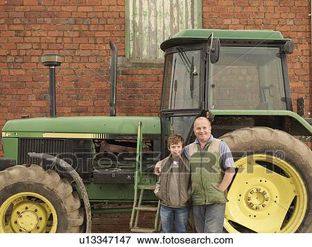 Stock Photo - Farmer And Son With Tractor. Fotosearch