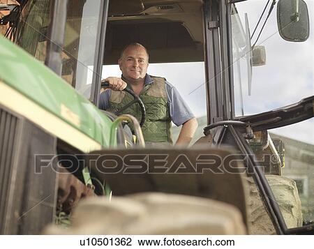 Stock Image - Farmer In Tractor. Fotosearch