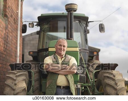Farmer Standing In Front Of Tractor View Large Photo Image Stock Photo - Farmer Standing In Front Of Tractor. Fotosearch