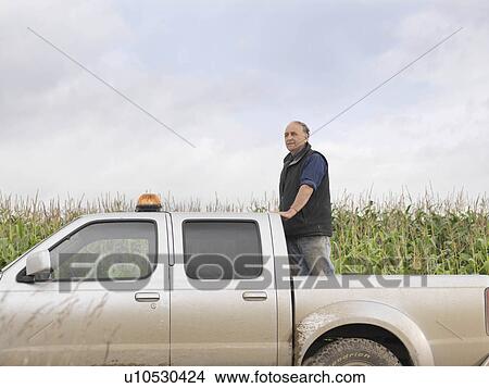 Farmer Standing In Pickup Truck View Large Photo Image Picture - Farmer Standing In Pickup Truck. Fotosearch