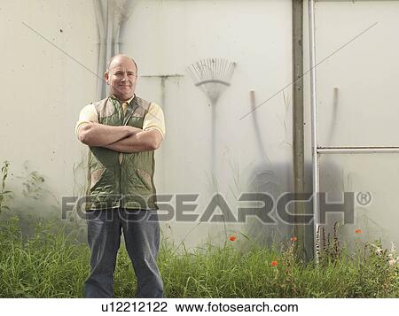 Farmer Standing Outside Polytunnel View Large Photo Image Stock Image - Farmer Standing Outside Polytunnel. Fotosearch