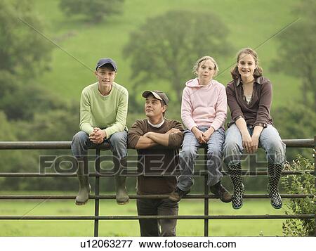Stock Photo - Farmer With Children On Gate. Fotosearch