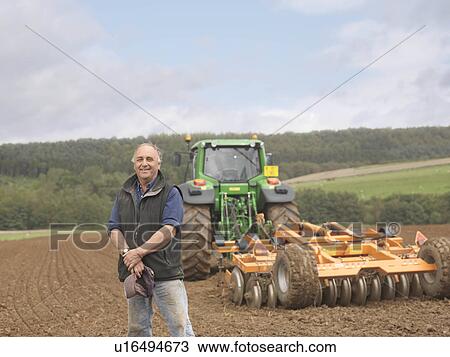 Farmer With Tractor In Field View Large Photo Image Stock Image - Farmer With Tractor In Field. Fotosearch