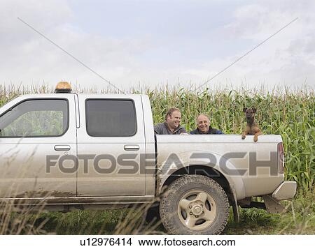 Picture - Farmers And Dog In Pickup Truck. Fotosearch