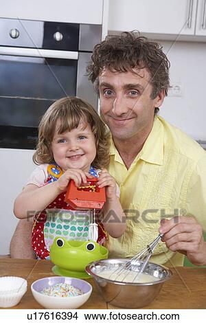 Father and daughter, stirring batter View Large Photo Image Picture - Father and daughter, stirring batter. Fotosearch
