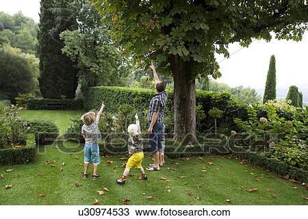 Stock Image - father with boys pointing. Fotosearch