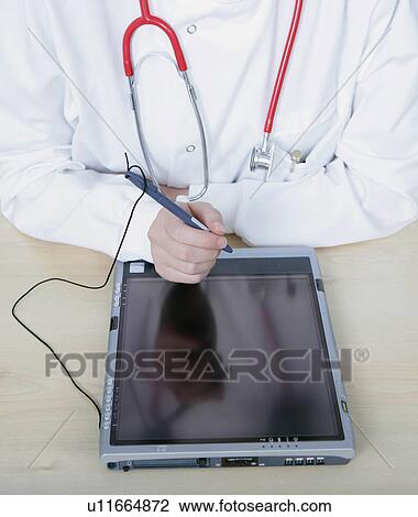 Stock Image - Female doctor using tablet pc. Fotosearch